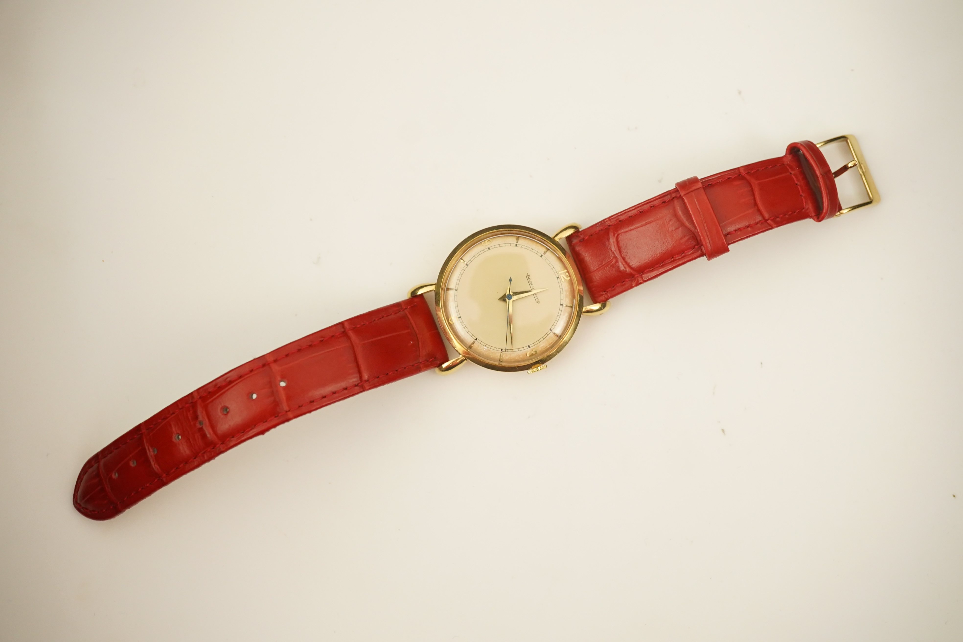 A gentleman's 1950's 18ct gold Jaeger LeCoultre manual wind wrist watch, on a later associated leather strap